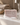 Savon de Marseille musc avec de la mousse sur un lavabo, serviette beige et plateau en bois, robinet ouvert